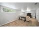 Finished basement with carpet, neutral paint, light neutral sofa, and several windows at 1243 Monroe St, Denver, CO 80206