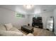 Inviting finished basement features a neutral sofa, television, and plush carpeted flooring at 1243 Monroe St, Denver, CO 80206