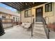 Back patio with seating and stairs leading to the back door at 1243 Monroe St, Denver, CO 80206
