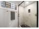 Modern walk-in shower featuring glass doors, gray tile, and a stylish towel bar at 1243 Monroe St, Denver, CO 80206