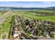Aerial view of the neighborhood with lake and green fields in the background at 9162 W Unser Ave, Littleton, CO 80128