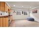 Cozy basement featuring a kitchenette, two windows, and a comfortable blue beanbag chair at 9162 W Unser Ave, Littleton, CO 80128