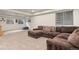 Carpeted basement with natural light, a comfortable sectional sofa, and a cozy blue beanbag chair at 9162 W Unser Ave, Littleton, CO 80128