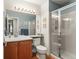Well-lit bathroom featuring a glass-enclosed shower and a vanity with generous counter space at 9162 W Unser Ave, Littleton, CO 80128