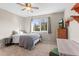 Cozy bedroom with a ceiling fan, plush carpeting, and a large window for natural light at 9162 W Unser Ave, Littleton, CO 80128