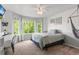 Bright bedroom with large bay windows offering views of the yard at 9162 W Unser Ave, Littleton, CO 80128