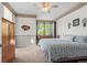 Inviting bedroom featuring natural light, carpet, ceiling fan, and a window with a view to the outside at 9162 W Unser Ave, Littleton, CO 80128
