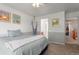 Light-filled bedroom featuring soft carpeting and easy access to an adjoining bathroom at 9162 W Unser Ave, Littleton, CO 80128