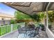Outdoor deck with awning, table, and chairs, surrounded by a well-maintained backyard at 9162 W Unser Ave, Littleton, CO 80128