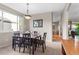 Elegant dining room with a wooden table and chandelier, next to the living room at 9162 W Unser Ave, Littleton, CO 80128