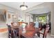Formal dining room featuring a dark wooden table, modern chandelier, and open concept layout at 9162 W Unser Ave, Littleton, CO 80128