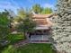 Beautiful home with a well-kept lawn, mature trees, and an inviting outdoor deck at 9162 W Unser Ave, Littleton, CO 80128