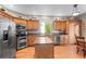 Spacious kitchen with stainless steel appliances, light wood cabinets, and a center island at 9162 W Unser Ave, Littleton, CO 80128
