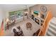 Living room featuring fireplace, media center, outside patio, stairs to the second floor, and a ceiling fan at 9162 W Unser Ave, Littleton, CO 80128