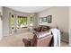 Bright living room featuring a bay window, neutral walls, and a comfortable leather sofa at 9162 W Unser Ave, Littleton, CO 80128