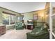 Comfortable living room area with green walls, sofa, chair, carpet, and a well-lit cozy atmosphere at 9162 W Unser Ave, Littleton, CO 80128