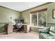 Functional home office with desk, chair, natural light from a large window, and neutral carpet at 9162 W Unser Ave, Littleton, CO 80128