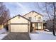 Two-story house with attached garage and landscaping, snow-covered yard at 4632 S Ensenada St, Centennial, CO 80015