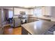 L-shaped kitchen with granite countertops and ample cabinet space at 4632 S Ensenada St, Centennial, CO 80015