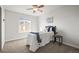 Bedroom with baseball decor, a ceiling fan, carpet and natural light from the double windows looking out to the neighborhood at 17026 River Birch Pt, Monument, CO 80132