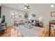 Bright living room with wood floors, neutral tones, and a large window at 17026 River Birch Pt, Monument, CO 80132