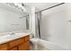 Well-maintained bathroom featuring a tub and shower combo with a wooden vanity at 11905 E Harvard Ave # 208, Aurora, CO 80014