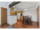 Charming kitchen and dining area with wood cabinets, modern appliances, and hardwood floors at 11905 E Harvard Ave # 208, Aurora, CO 80014