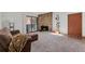 Bright living room featuring a stone fireplace, sliding glass doors and plush carpeting at 11905 E Harvard Ave # 208, Aurora, CO 80014