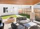 Covered patio with fire pit, seating area, and artificial turf at 1576 W Maple Ave, Denver, CO 80223