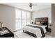 Bright bedroom with large window and wood headboard at 1576 W Maple Ave, Denver, CO 80223