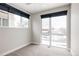 Bedroom with window and sliding door to exterior at 1576 W Maple Ave, Denver, CO 80223