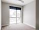 Bright bedroom with large window and ceiling fan at 1576 W Maple Ave, Denver, CO 80223