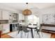 Modern dining room with a wood table and woven pendant light at 1576 W Maple Ave, Denver, CO 80223