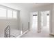 Upper hallway with light gray walls and carpet at 1576 W Maple Ave, Denver, CO 80223