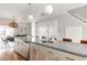 Modern kitchen with island, stainless steel appliances, and hardwood floors at 1576 W Maple Ave, Denver, CO 80223