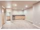 Carpeted basement including a small kitchenette with cabinets, countertop and sink at 4137 Clifton Ct, Boulder, CO 80301