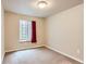 Simple carpeted bedroom featuring a window with a view, neutral walls and minimal decor at 4137 Clifton Ct, Boulder, CO 80301