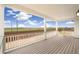Covered back porch with scenic views of green space and a wooden fence, great for outdoor entertaining at 11124 Xanadu St, Commerce City, CO 80022