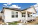 Charming covered porch on this new construction home with white siding, a grey roof and white railings at 11124 Xanadu St, Commerce City, CO 80022