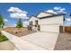 Beautiful single-Gathering home with a two car garage, stone accents, a paved driveway and fresh landscaping at 11124 Xanadu St, Commerce City, CO 80022