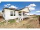 New construction home with a covered porch, white siding, a grey roof and freshly laid landscaping at 11124 Xanadu St, Commerce City, CO 80022