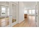 Bright hallway featuring light wood floors and view of the kitchen area at 11124 Xanadu St, Commerce City, CO 80022