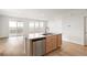 Modern kitchen island with a stainless steel dishwasher and a view into the bright, open living space at 11124 Xanadu St, Commerce City, CO 80022