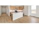 Bright kitchen with modern cabinets and a large central island with a breakfast bar at 11124 Xanadu St, Commerce City, CO 80022