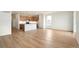 Bright living room with an open floor plan and a spacious kitchen area at 11124 Xanadu St, Commerce City, CO 80022