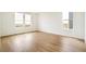 Bright room with light wood floors and two large windows at 11124 Xanadu St, Commerce City, CO 80022