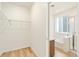 Walk-in closet leading into bathroom with shower and tub at 11124 Xanadu St, Commerce City, CO 80022