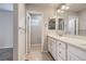 Bathroom featuring a double vanity, large mirror, and a separate toilet room at 14176 Jackson St, Thornton, CO 80602