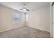Neutral carpeted bedroom with neutral walls, ceiling fan, and large window at 14176 Jackson St, Thornton, CO 80602