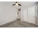 A comfortable bedroom with neutral paint and carpet, a ceiling fan, and closet with sliding doors at 14176 Jackson St, Thornton, CO 80602